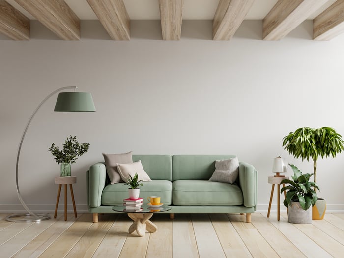 A living room with a green sofa.