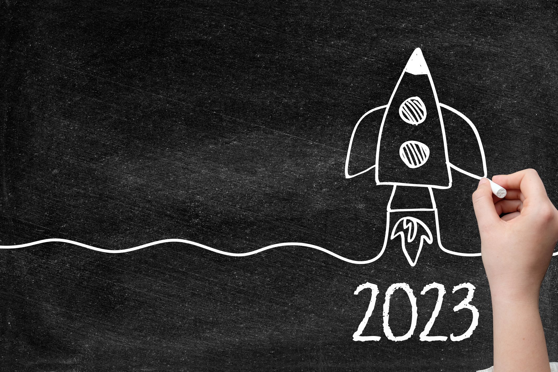 Blackboard drawing of a rocket launching labeled 2023