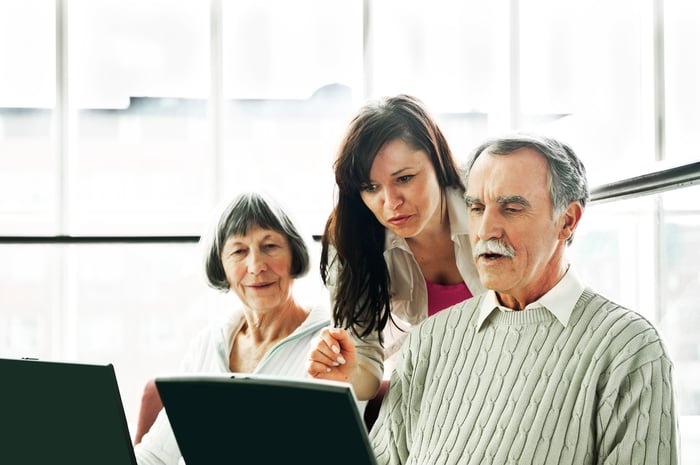 People looking at laptop.