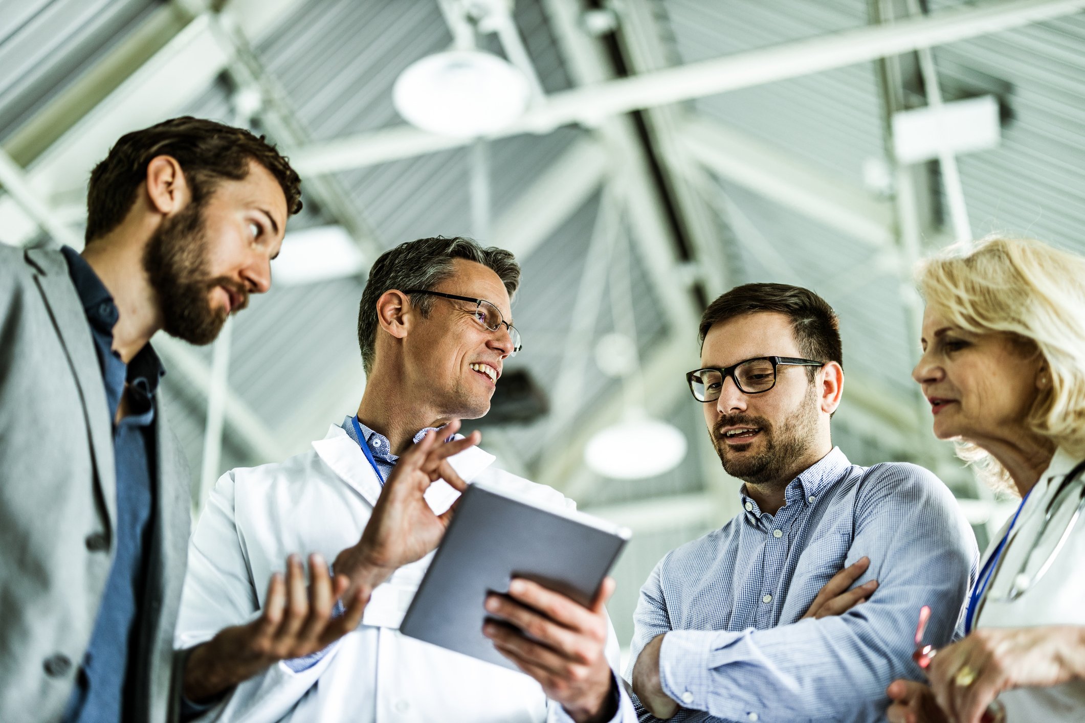 businessmen and doctors working on touchpad in a hospital
