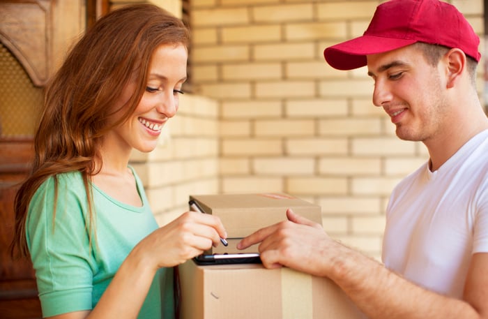 A person signs for a package.