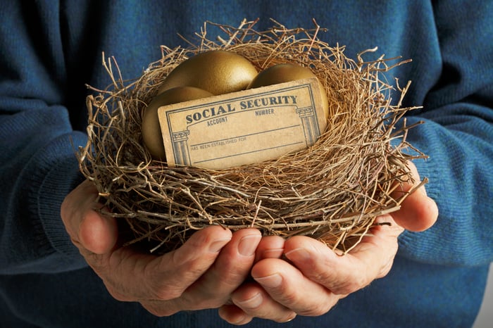 Golden eggs and Social Security card in a nest.