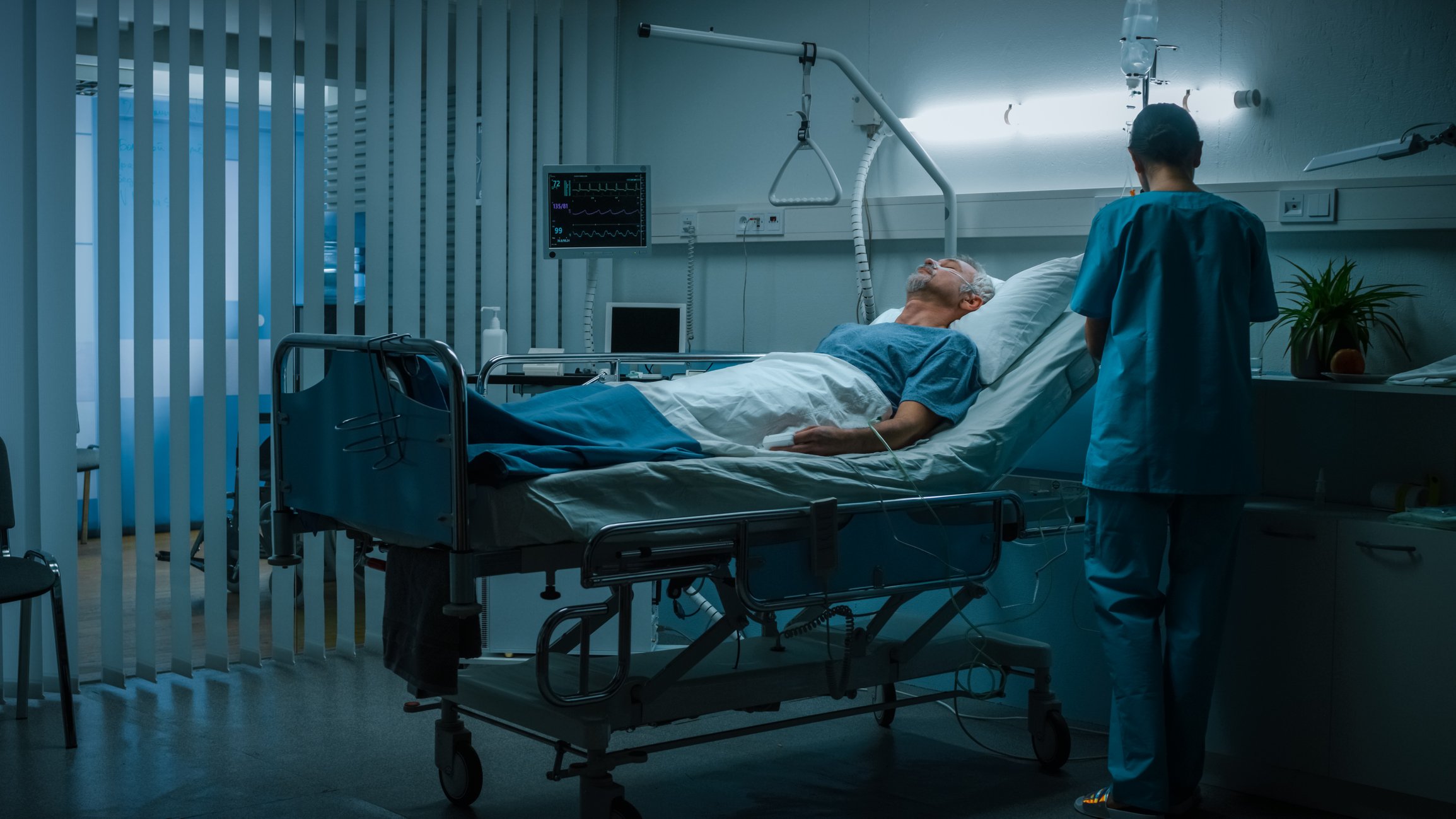 Senior Patient Rests on the Bed, Nurse in Ward Does Checkup