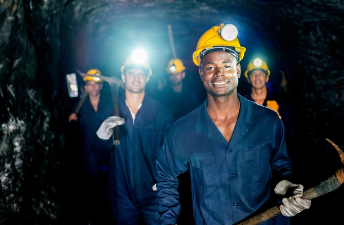 Miners walking in a group in a mine.