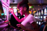 woman at slot machine gambling