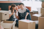 Person with packing boxes in home.