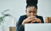 person looking worried or concerned at laptop.