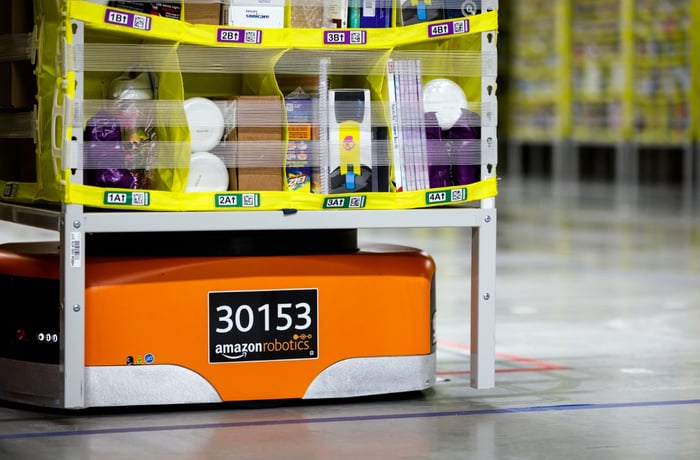 An Amazon robot moving a large bin loader with merchandise. 
