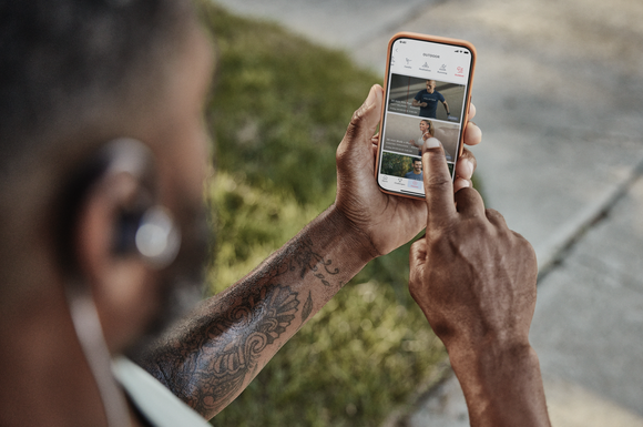 A Peloton member engaging with the app outdoors.