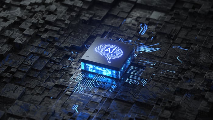 A digital rendering of a circuit board with a chip in the middle and an AI engraved on it.