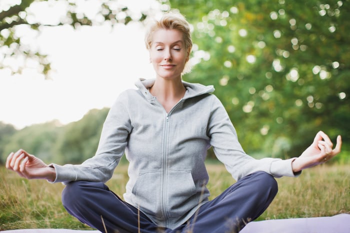 Relaxed person meditating in a field.