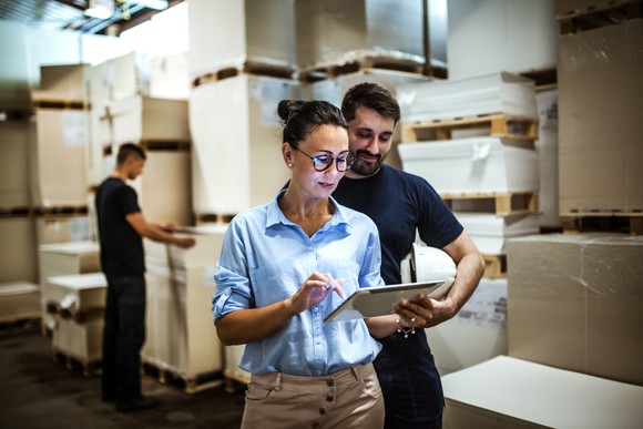 People reviewing orders in a logistics center.