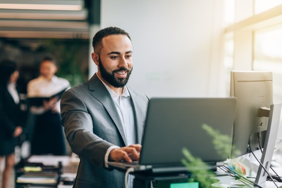 A businessperson works on a laptop.