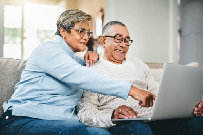 Two people at a laptop.