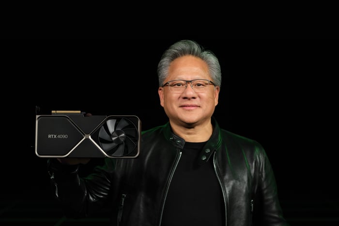 Nvidia CEO Jensen Huang holds an RTX graphics card.