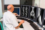 radiologist of Oncology institute is examing MRI scans