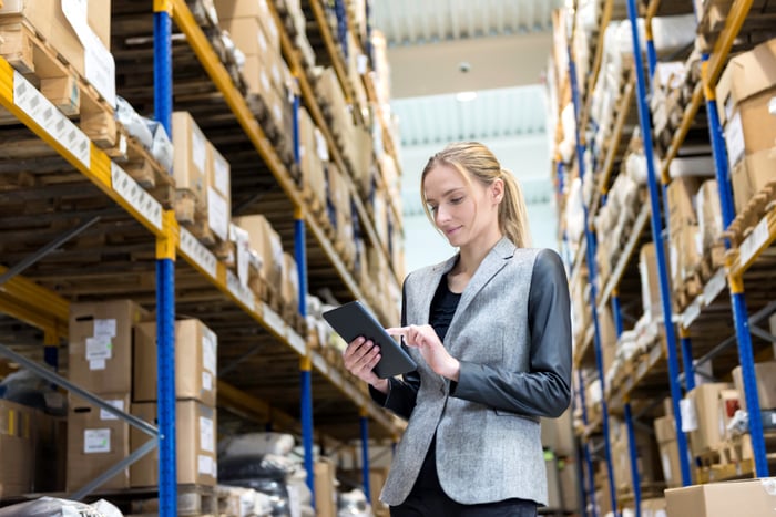 A person in a warehouse working on the fulfillment of online orders.