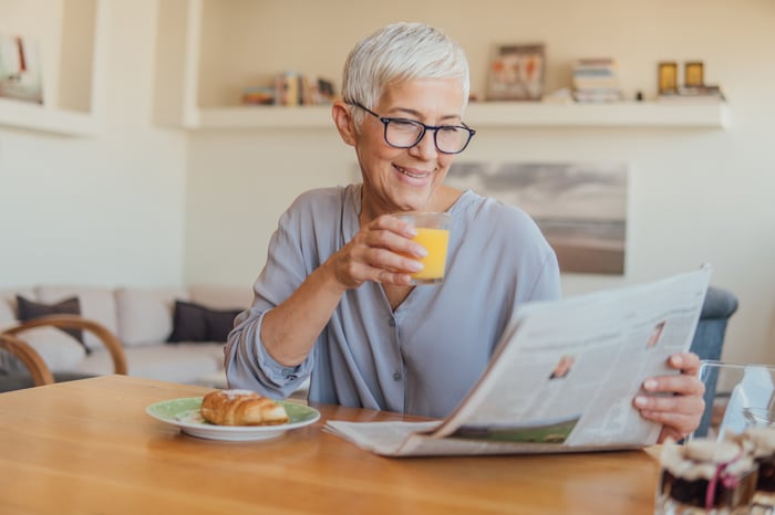 A person reading a newspaper.