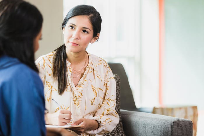 One person advising another. 