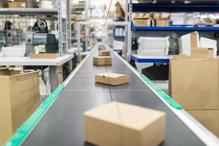 Cardboard boxes on a conveyor belt.