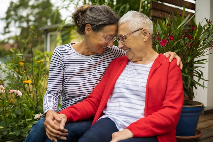 Two people smiling at each other. 