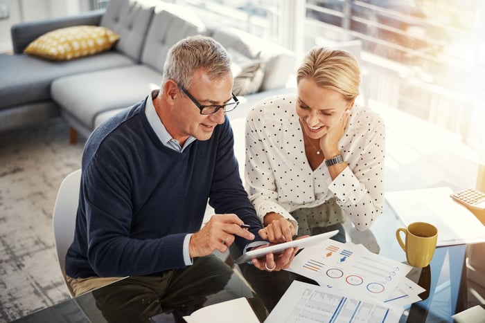 Couple reviewing their finances at the table.