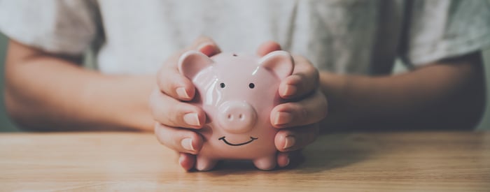 A person holding a piggybank.
