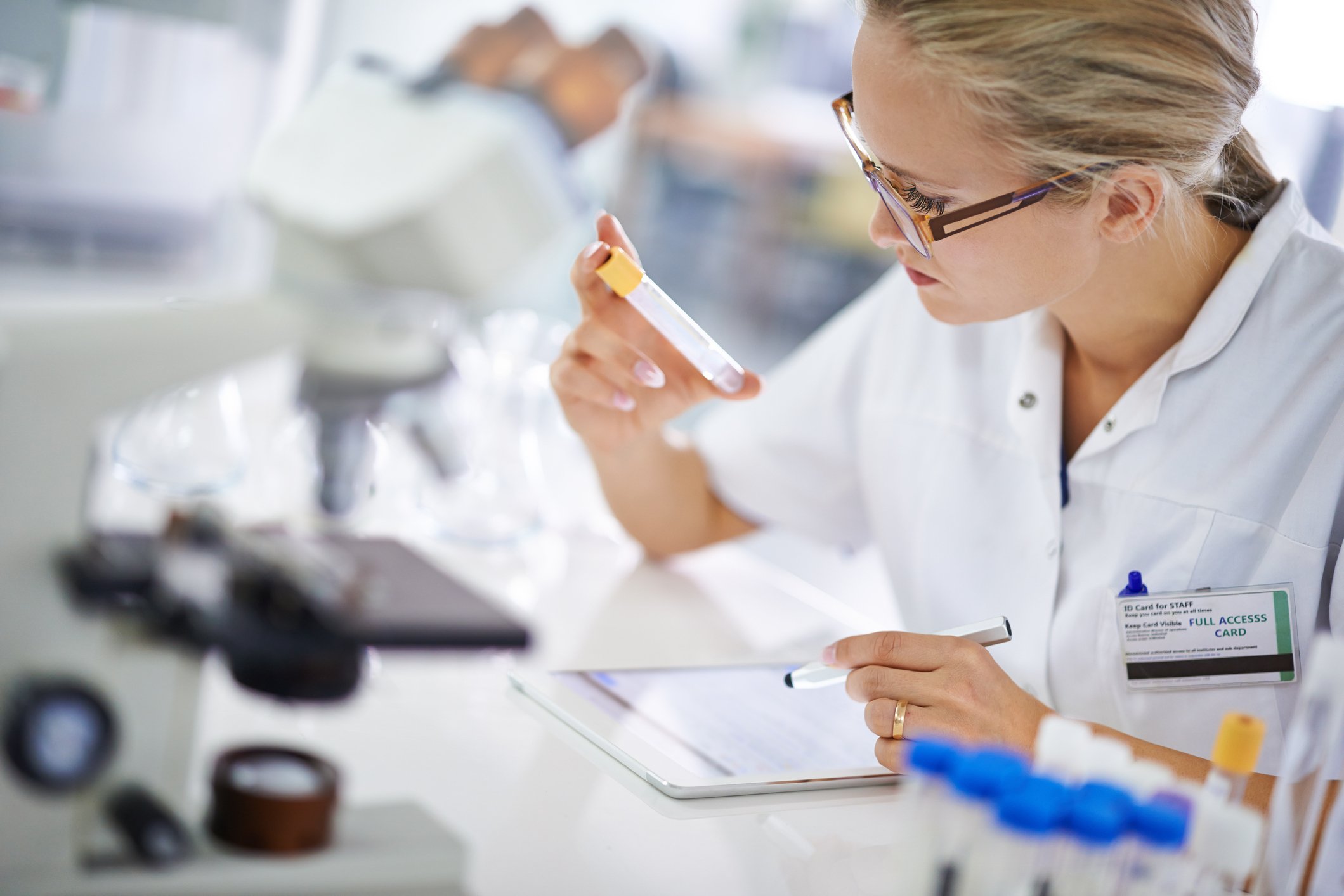 A young scientist recording her findings on a tablet