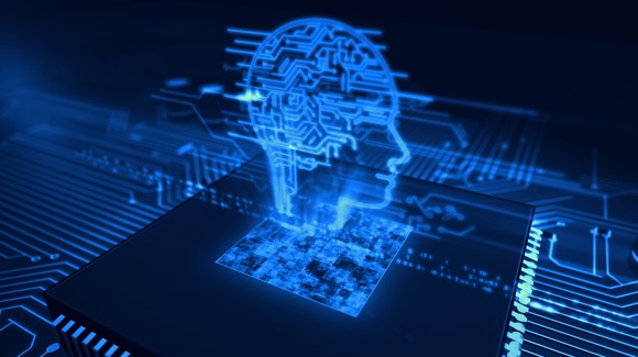 Hologram of a person's brain above a semiconductor -- concept for AI.