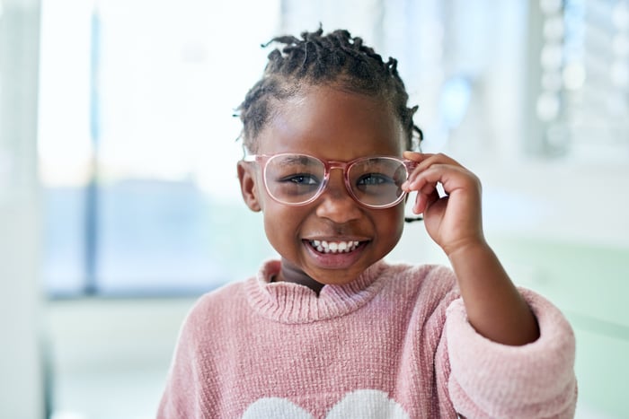 Child trying on new glasses.
