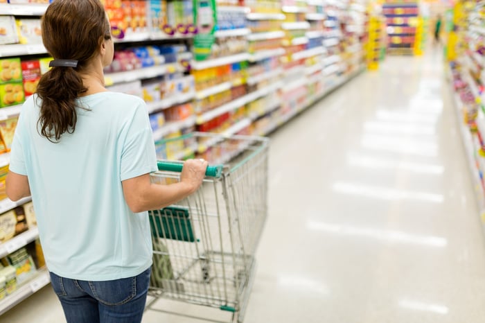 A person pushing a cart in a store.