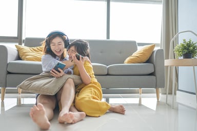 2 people in a room enjoying time on their smartphones