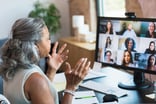 facilitates a staff meeting while working from home video conference