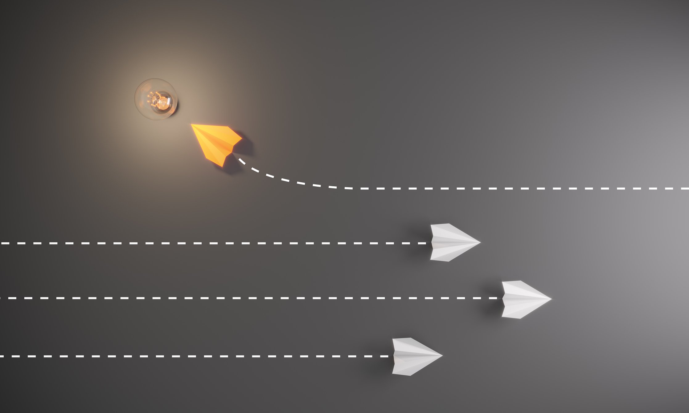 Group of paper airplane in one direction and with one individual pointing in the different way getty