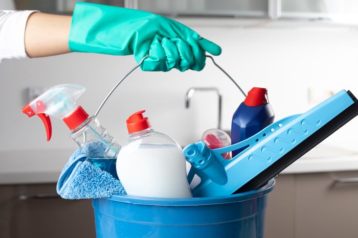 A collection of cleaning supplies in a bucket.