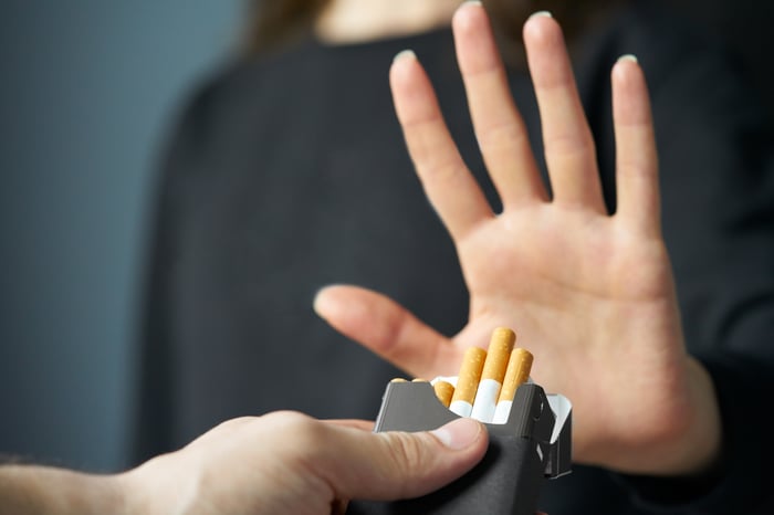 A person putting their hand up to say no to tobacco cigarettes.