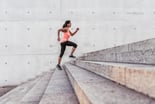 woman running up outdoor stairway