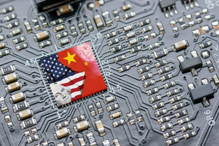 U.S. and Chinese flags superimposed on a semiconductor.