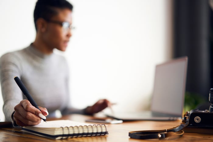 A person works on a laptop.