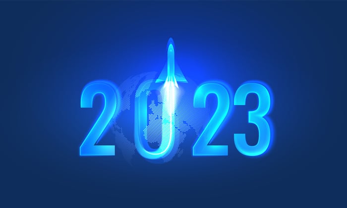 2023 in neon blue with a rocket launching out of the 0.