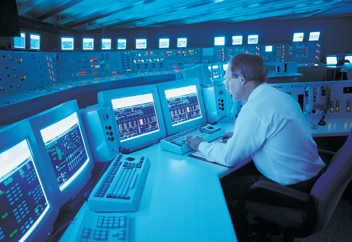 A person in a nuclear power plant control room.