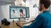 person using photoshop on computer