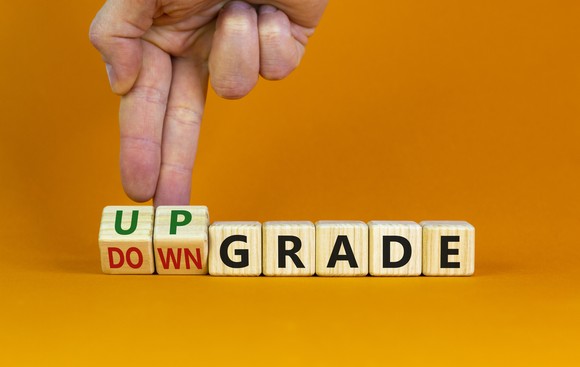 A hand moves two blocks with the words up and down on them next to other blocks that spell out GRADE