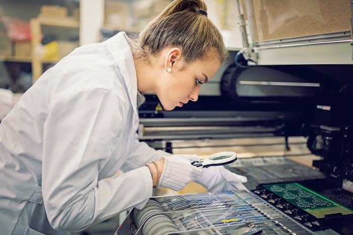 A person analyzing a circuit board.