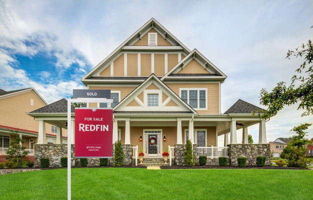A Redfin for sale sign in front of a house