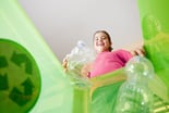 young girl recycling bottles