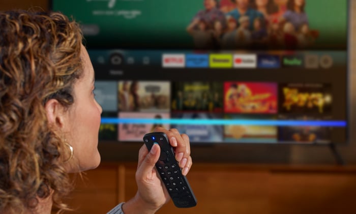Voice remote being used by person on TV.