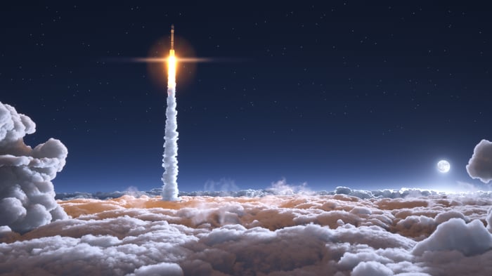 A rocket blasting through the clouds to space.