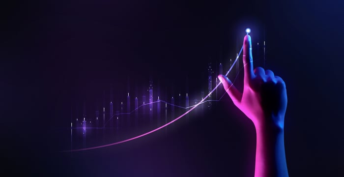 A hand drawing an exponential curve.