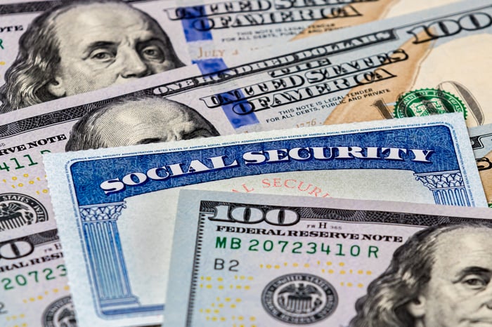 A Social Security card in between $100 bills.